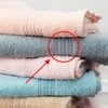 Stack of clean soft colorful towels with graphic treatment